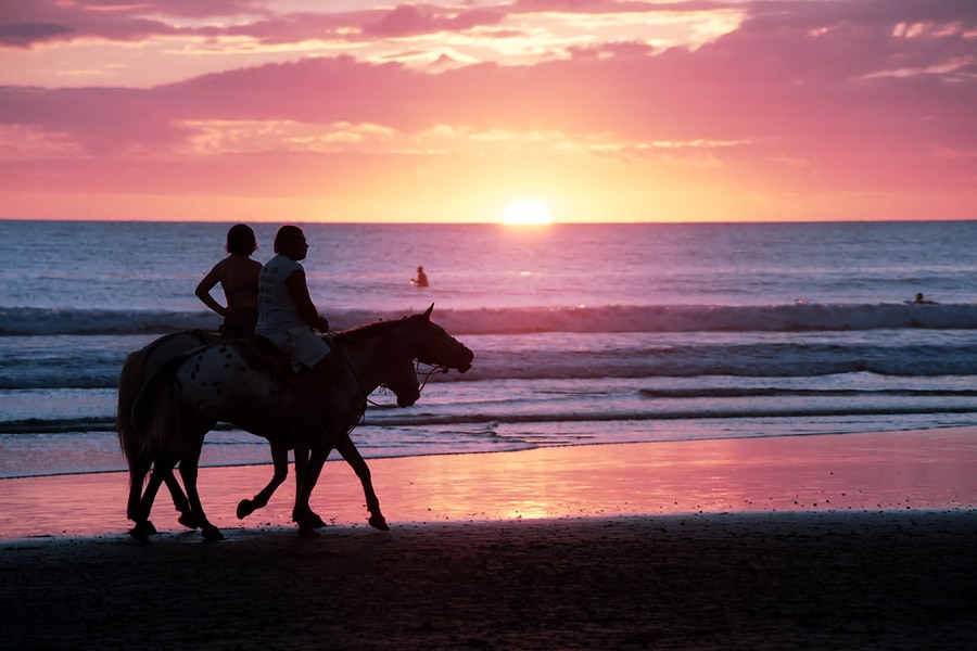 Horseback riding at sunset on the beach in Costa Rica